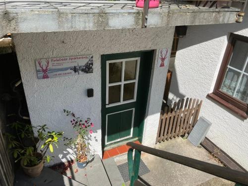 a house with a green door and a window at PinkDeer in Hallstatt