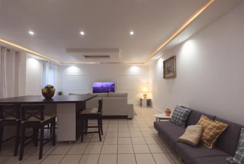a living room with a couch and a table at Grande maison des Compagnons in Val de Reuil