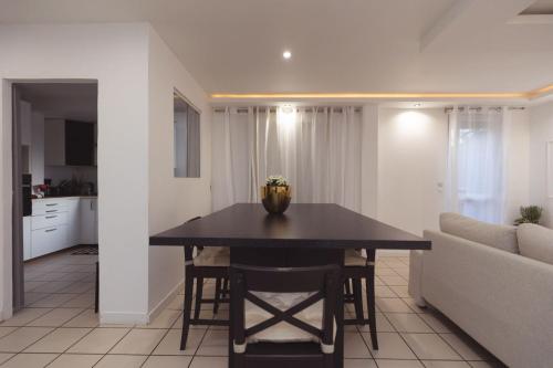 a kitchen and living room with a table and a couch at Grande maison des Compagnons in Val de Reuil
