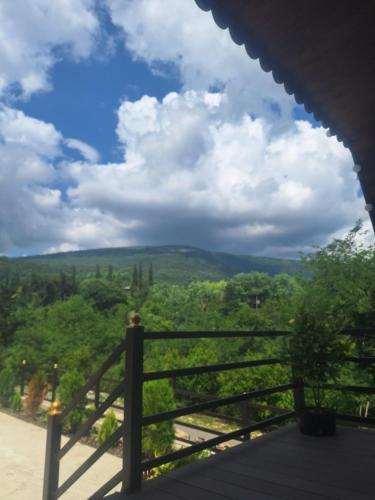 a view from the porch of a house with a fence at Green Paradise Martvili Cottege in Martvili
