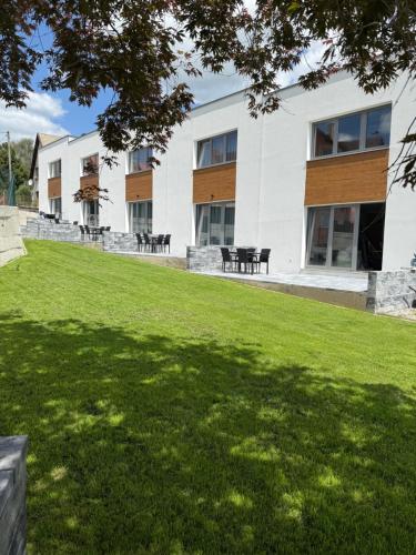 a building with a lawn in front of it at Diamond Houses in Námestovo