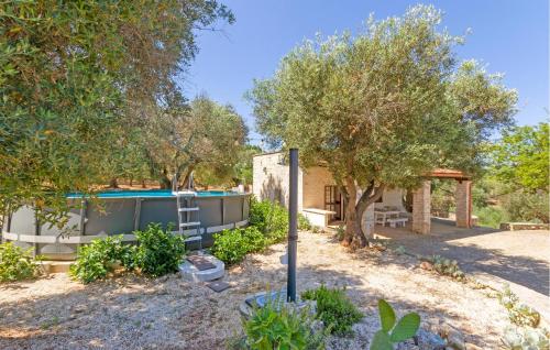 a house with a swimming pool and trees at Casale Valle Degli Ulivi in Ostuni
