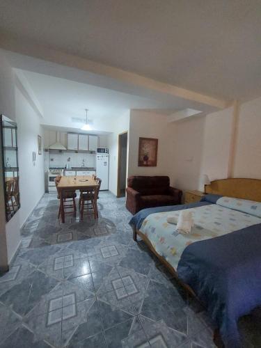 a bedroom with a bed and a table in a room at Colorina Complejo Residencial in San Rafael