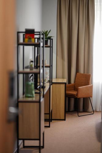 a living room with a desk and a chair at Felinger Concept Hotel in Yerevan