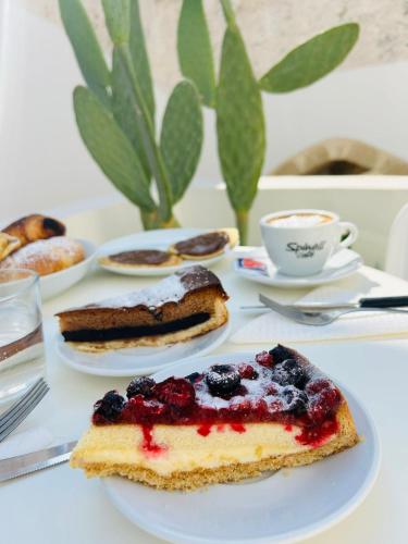 a plate with a piece of cake with berries on it at Regina Elena Suites & Private SPA in Sannicola
