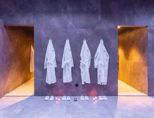 a group of white clothes hanging on a wall at Ocak Hotel in Berlin