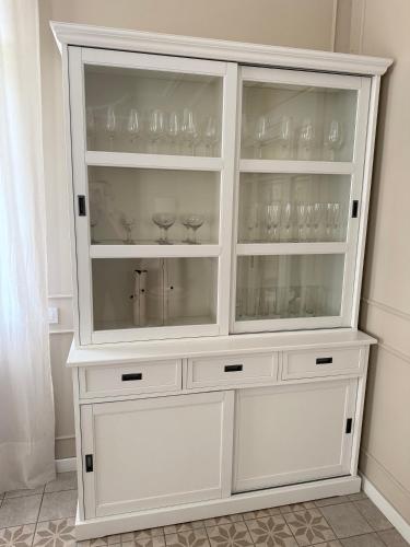 a white hutch with wine glasses in it at La Torre de Guardiola in Guardiola de Berguedà
