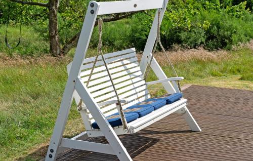 a white rocking chair sitting on a deck at 2 Bedroom Beautiful Home In Skjern in Skjern