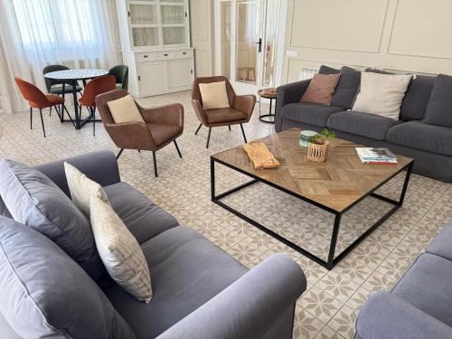 a living room with couches and a table and chairs at La Torre de Guardiola in Guardiola de Berguedà