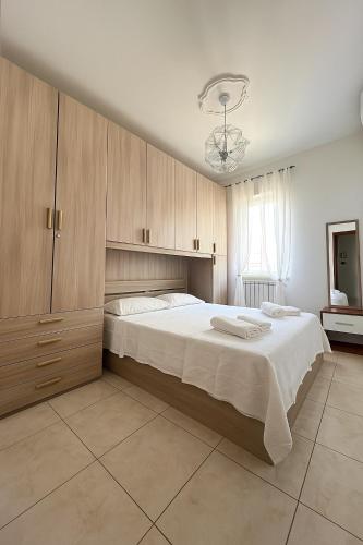 a bedroom with a large bed with wooden cabinets at Casa Stella in Crotone