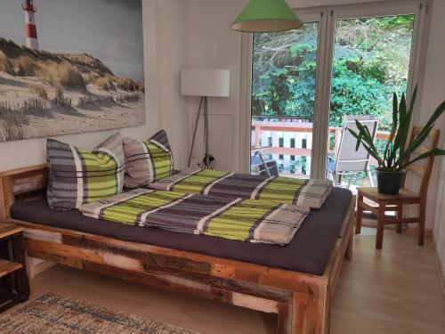 a bed in a room with a large window at Kutscherwohnung in Kiel