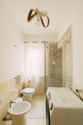 a bathroom with a sink and a toilet and a shower at Casa Stella in Crotone