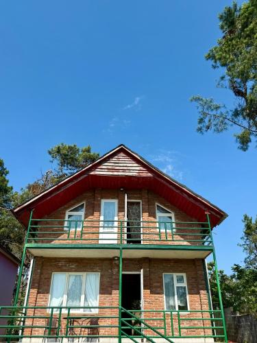 an old brick house with a balcony on top of it at Sunset in Shekvetili in Shekvetili