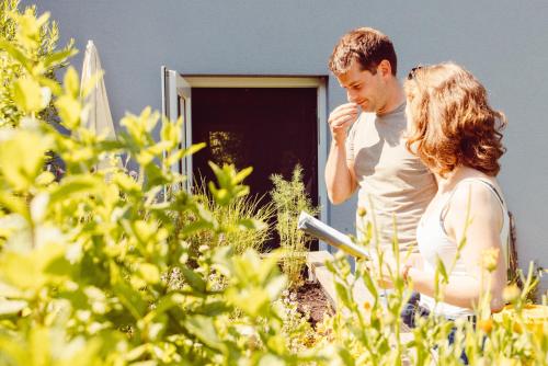 a man and a woman standing in front of a house at Camping Liefrange in Liefrange