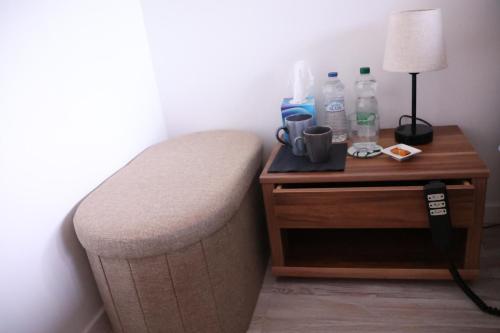 a room with a bed with a night stand with a lamp at Chez Marie in Rosheim
