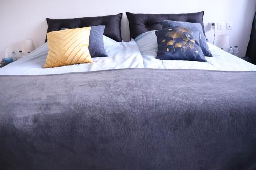 a bed with pillows on it in a bedroom at Chez Marie in Rosheim