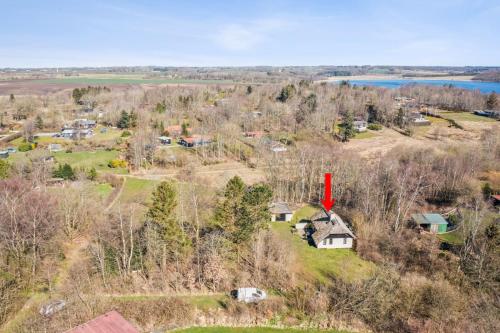 an aerial view of a small town with houses and a lake at Astrup Vig Hideaway, Thatched Cottage with Shelter & Serenity in Roslev