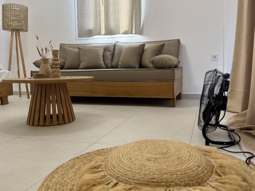 a living room with a couch and a table at Aenya Kythnos Villas in Kithnos