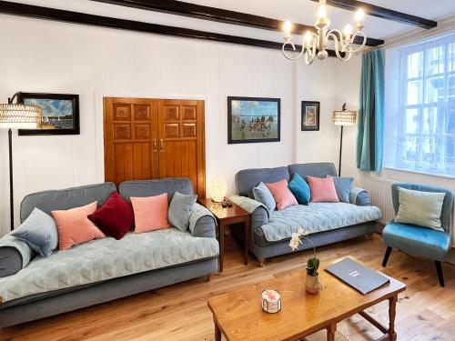 a living room with two couches and a table at The Anchor in Scarborough