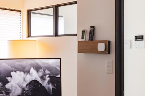 a room with a door with a picture on the wall at First Choice in Tokyo