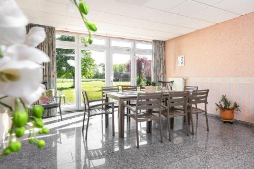 a dining room with a table and chairs at Hotel Heilemann in Wietmarschen