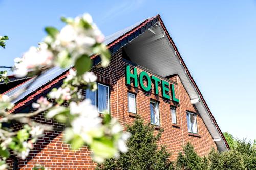 a hotel sign on the side of a brick building at Hotel Heilemann in Wietmarschen