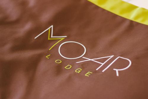 a close up of the zon bounce sign on a blanket at Moar Lodge in Postal