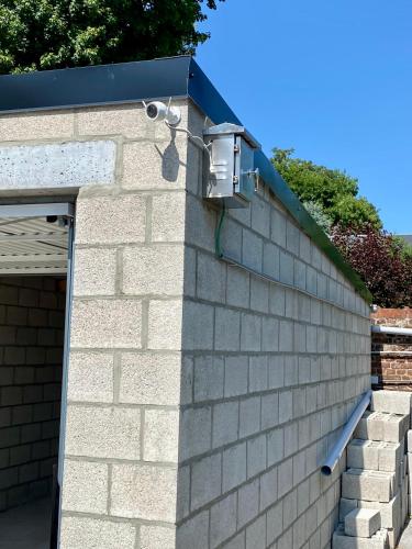 a brick wall with a security camera on it at Hôtel VCB Ciney Centre-ville in Ciney
