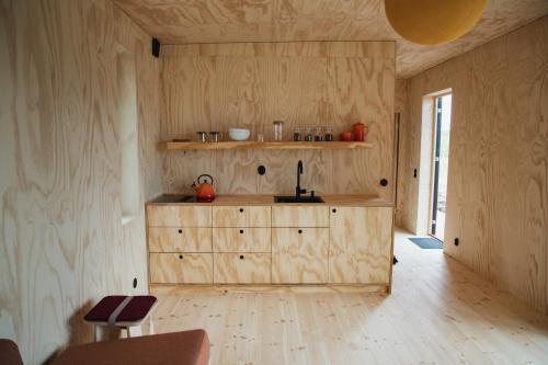 a kitchen with a wooden cabinet in a room at Sukha Nordic Retreats in Arvika