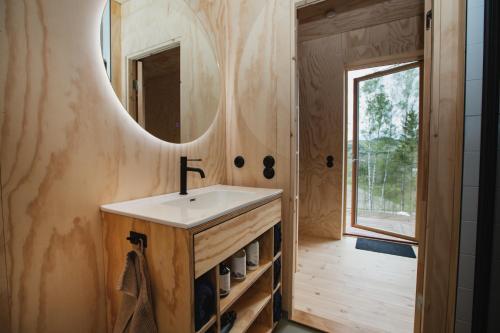 a bathroom with a sink and a mirror at Sukha Nordic Retreats in Arvika