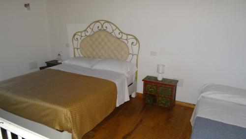 a bedroom with a large bed and a wooden floor at Borgo Rosso di Sera - Resort Country Chic in San Lucido