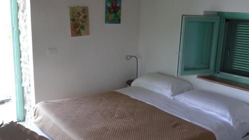 a bedroom with a bed and a window at Borgo Rosso di Sera - Resort Country Chic in San Lucido