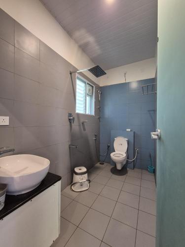 a bathroom with a sink and a toilet at Tropica Retreat by Dazzle Destinations - Private Waterfalls, Private Rooms and Bonfire in Aldūr