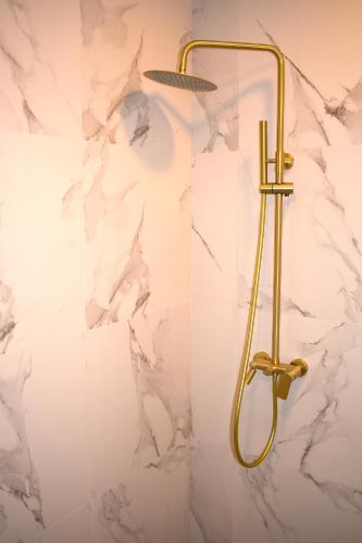 a shower in a bathroom with a marble wall at Queen of Durmitor in Žabljak
