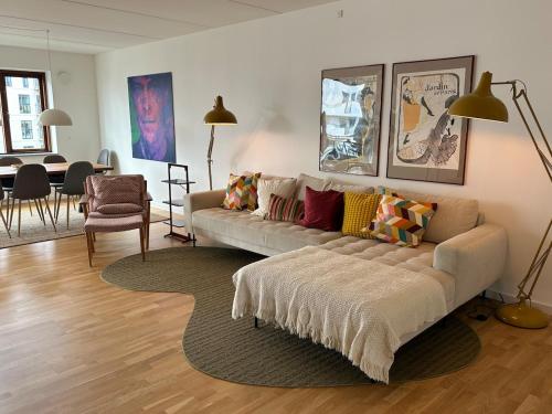 a living room with a couch and a dining room at On the beach, close to city centre & airport in Copenhagen
