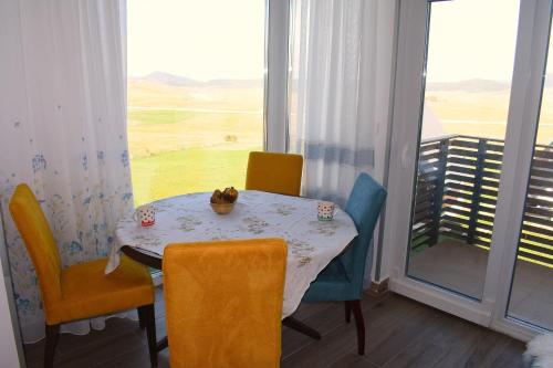 a dining room with a table and chairs and a window at Queen of Durmitor in Žabljak