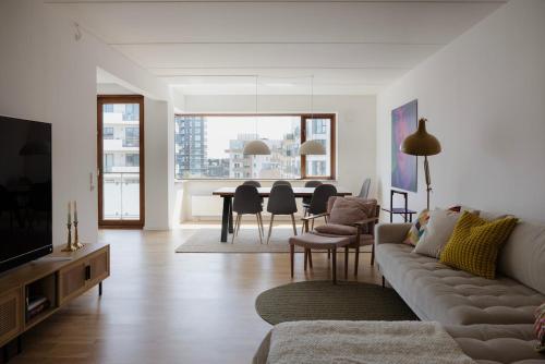 a living room with a couch and a table at On the beach, close to city centre & airport in Copenhagen