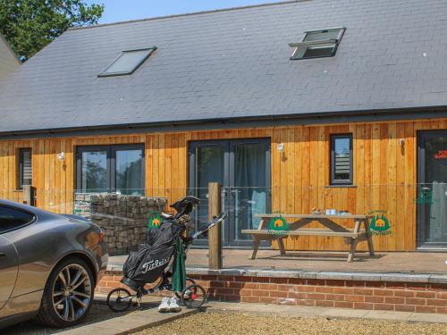 a person on a bike in front of a house at No 1 Fox Burrow-Uk44306 in Lenwade