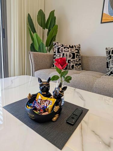 a bowl of snacks and a rose on a table at EliteStay by Al Amir in Cabo Negro