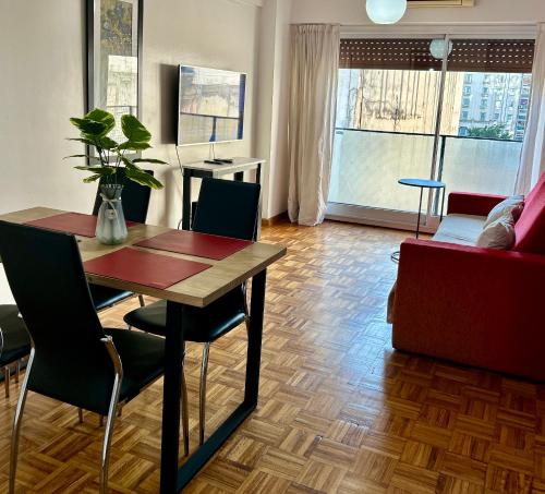 a living room with a table and chairs and a couch at Sarmiento Home in Buenos Aires