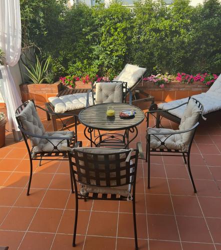 a patio with a table and chairs and a couch at Charming Beachfront Retreat in Riposto