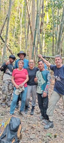 a group of people posing for a picture in the woods at Ratanakiri Farmhouse & Trekking in Banlung