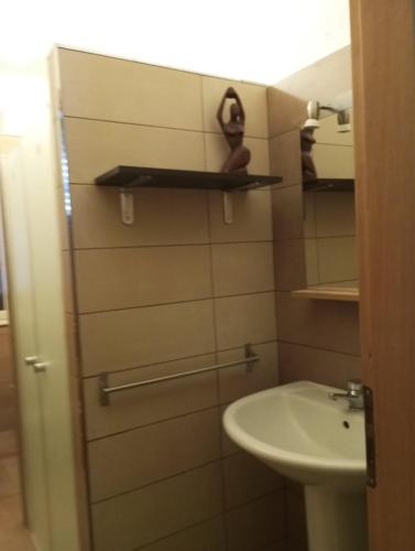 a small bathroom with a sink and a toilet at Mami house in Sambuca di Sicilia