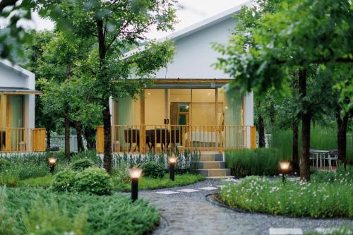 a house with a garden with lights in front of it at Naris phu view resort in Ban Pan Cho