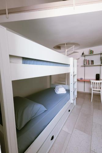 a white bunk bed in a room with a desk at Il Giardino della Giudecca Trani in Trani