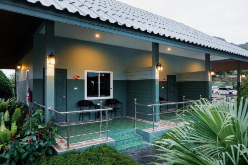 a house with two chairs sitting on the porch at Naris phu view resort in Ban Pan Cho