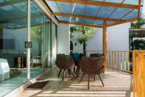 a deck with chairs and glass doors on a house at Naris phu view resort in Ban Pan Cho