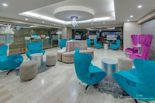 a lobby with blue chairs and a waiting room at Hotel Cartagena Plaza in Cartagena de Indias