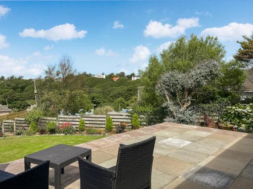 a patio with two chairs and a table at Fyebrae in Stranraer