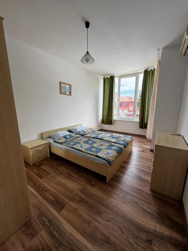 a bedroom with a bed and a large window at 'Oasis' Ravda Apartment, Nessebar in Ravda